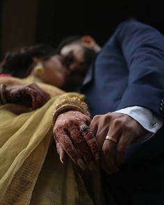 the bride and groom hold hands as they lay on their wedding day in front of each other