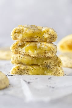 three cookies stacked on top of each other with poppy seed sprinkles around them