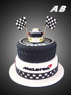 a cake made to look like a racing car on top of a tire with checkered flags