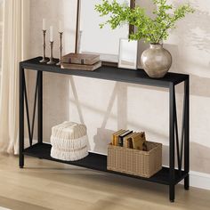 a black console table with books and a basket on the floor in front of it