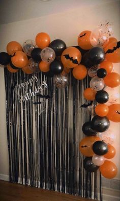 an orange and black halloween balloon arch