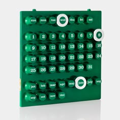 a green board with white numbers and circles on it's sides, showing the date for each month