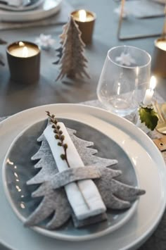 a table set for christmas with candles and napkins