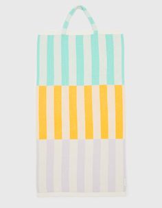 a white bag with blue, yellow and green stripes on the front is hanging from a hook