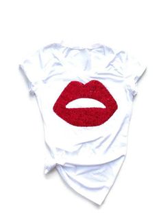 Sequin Lips women's tee. We specialize in women's unique, one of a kind, handmade sequin and graphic designs. No two shirts are alike since each piece is made by hand and a whole lot of love. We've got all your holiday and everyday shirts covered. Shop Love and Bambii. 100% ringspun cotton unisex crew neck tee. Heather colors are poly/cotton blend. We do have other shirt styles available for special order (no extra fee but may extend turnaround time) so please send me a message if there is somet Lipstick Shirt, Sequin Lips, Patches Jacket Diy, Embroidered Patch Diy, Lip Patch, Lips Shirt, Punk Patches, Bling Shirts, Iron On Embroidered Patches