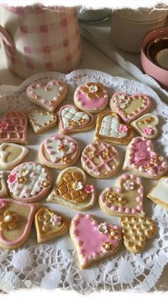 some heart shaped cookies are on a doily