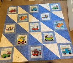 a blue and white quilt with cars on it