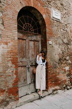 a woman standing in front of a wooden door