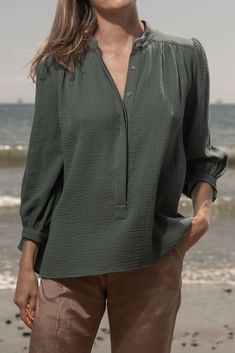 MARISH TOP The MARISH - made from our signature lightweight cotton gauze, this breezy top exudes casual elegance, making it the perfect choice for warm days and balmy nights. Designed with the relaxed coastal lifestyle in mind, the MARISH Top wears beautifully. Gauze Button Front Blouse 3/4 Slight Bishop Sleeve Button Cuff Mandarin Collar Front Gathers at Yoke Covered Placket Fabric: Double Cotton Gauze Lining: Unlined Care : Dry Clean Made in California Model is 5'9 and wearing size S Coastal Lifestyle, Fall Denim, Double Gaze, Bishop Sleeve, Fall Favorites, Kids Hats, Casual Elegance, Mandarin Collar, Socks For Sale