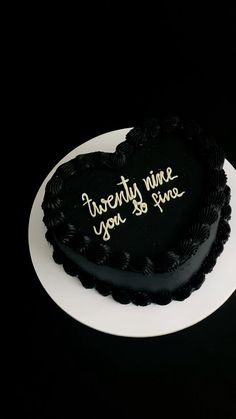 a heart shaped cake with writing on it