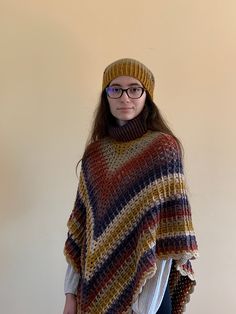 "*READY TO SHIP* This is my handmade, brown toned, crocheted poncho and beanie set for the Fall/Winter season. It is very soft and comfortable! Perfect to use for a fashionable outfit for going out. Color pattern is very appealing to eye and will stand out. Only ONE available.  Yarn used is 80% acrylic and 20% cotton. Model shown is 5'9\" and wears size medium. Handwash and natural dry only. Made in smoke free home. Just message me for any questions you may have. Check out my shop for other handmade, crocheted attire!" Cozy Warm Crochet Hat For Fall, Warm Cozy Crochet Hat For Fall, Cozy Crochet Hat For Cold Fall Weather, One-size Crochet Hat For Cold Weather In Fall, One Size Crochet Hat For Cold Weather In Fall, Crochet Hat For Fall Cold Weather, One Size, Fall Crochet Hat For Cold Weather, Cozy Slouchy Crochet Hat For Fall, Slouchy Cozy Crochet Hat For Fall