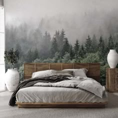 a bedroom with a forest mural on the wall