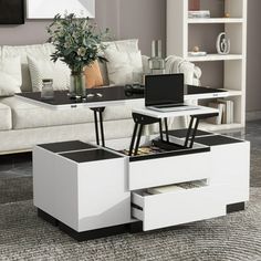 a living room with a couch, coffee table and bookshelf on the floor