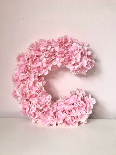 the letter c is made out of pink flowers