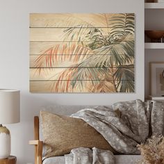 a living room scene with focus on the couch and palm tree wall art above it