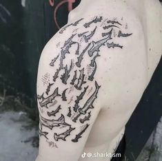 the back of a man's shoulder with many birds on it