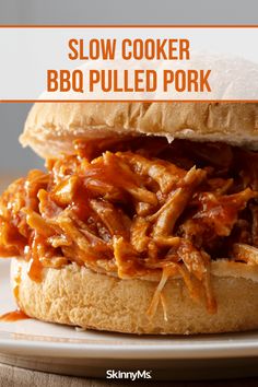 the slow cooker bbq pulled pork sandwich is on a white plate with text overlay