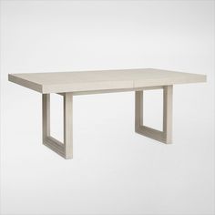 a white table sitting on top of a white floor