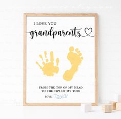 a framed print with the words i love you grandparents and handprints on it