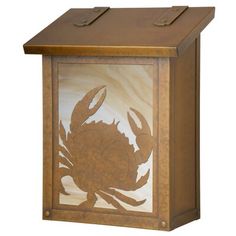 a wooden box that has a crab on the front and sides, with an etched design