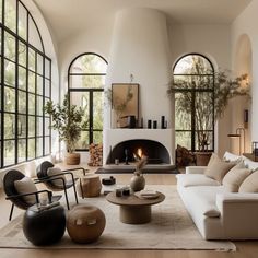 a living room filled with lots of furniture next to a fire place in a building