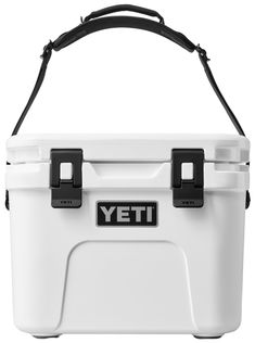 a white yeti cooler with black handles