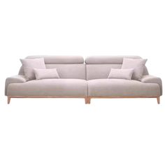 a white couch with two pillows on top of it and one arm extended to the side