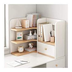 a white desk topped with lots of drawers next to a mirror and window sill