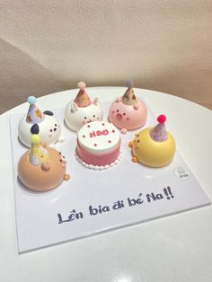 there are many small cakes on top of the card that says it's birthday