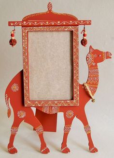 an ornament shaped like a cow with a frame