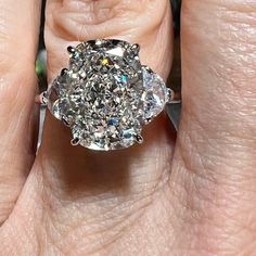 a woman's hand with a diamond ring on it