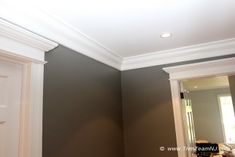 an empty room with gray walls and white trim