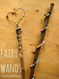 two wands with beads on them sitting next to each other and the words fairy wands written in white