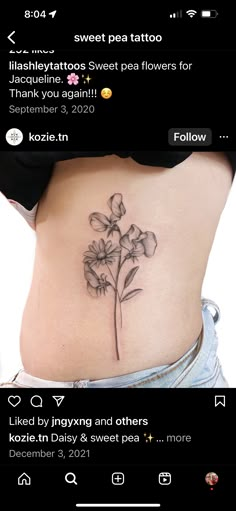 a woman's stomach with a flower tattoo on it