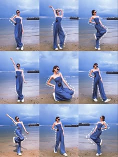 the woman is posing on the beach with her arms in the air