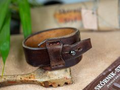 Genuine leather bracelet decorated with Baltic amber for a unique woman. This unique bracelet was made entirely by hand from a single piece of thick cowhide. dimensions: - thickness 4-5 mm - width at the widest point 3.8 cm - max inner circumference of the fastened bracelet 18.5 cm - fits wrist up to 17 cm in circumference This unique bracelet will be the best gift for your beloved woman. Adjustable Leather Bracelet With Strap, Adjustable Leather Cuff Bracelet With Bracelet Strap, Adjustable Leather Bracelet With Wrist Strap, Adjustable Leather Wristband With Bracelet Strap, Adjustable Leather Strap Wristband, Adjustable Leather Wristband With Waxed Finish, Adjustable Waxed Leather Bracelet, Leather Bracelet With Strap As Gift, Hand Tooled Adjustable Leather Bracelets