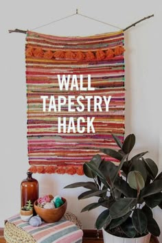 a wall tapestry with the words wall tapestry hack on it next to a potted plant