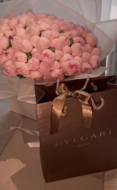 a bouquet of pink roses in a brown paper bag