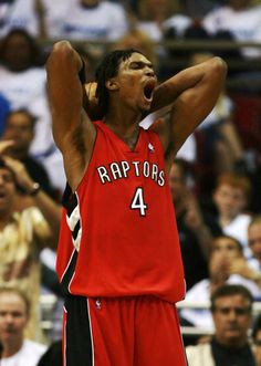 a basketball player holding his head up in the air with his hands to his face