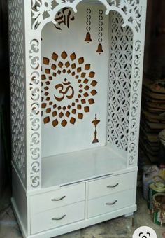 a white cabinet with an intricate design on it