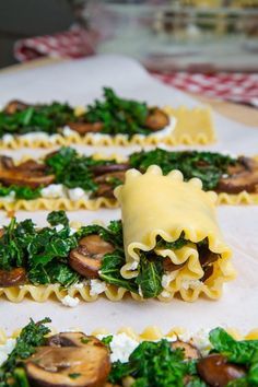 pasta shells with spinach and mushrooms on them