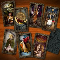 six tarot cards with pictures of women and men in them on a wooden surface