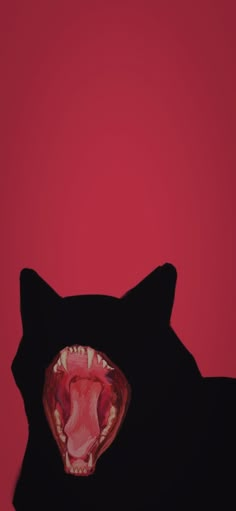 a black cat with its mouth open in front of a red background