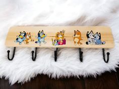 a wooden coat rack with cartoon characters on it