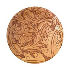 an intricately carved wooden plate on a white background