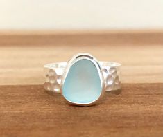 This is a sterling silver light blue sea glass ring. The beach glass is hand tumbled and made from recycled glass and bezeled onto a thick hammered band. The band measures 7mm wide and is textured making the light reflect off of the band. The sea glass pieces vary in shape in size but measures about 9x7mm-12x12mm, each ring is slightly different. This beach glass ring reminds me of the beautiful blue waters in the Bahamas and makes a perfect gift for the ocean lovers in your life. The ring comes Sea Inspired Rings, Sea Glass Rings Sterling Silver, Seaglass Rings, Made For Mermaids, Ocean Ring, Sea Glass Ring, Handmade Silver Jewellery, Sea Glass Bracelet, Beachglass Jewelry