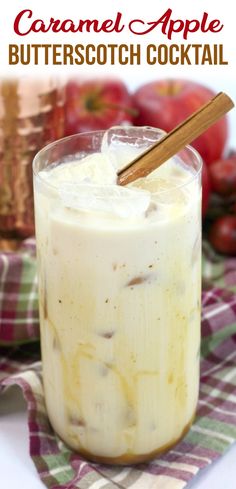 caramel apple butterscotch cocktail in a glass on a plaid napkin with cinnamon stick