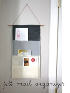 a wall hanging on the side of a door with mail and postcards attached to it