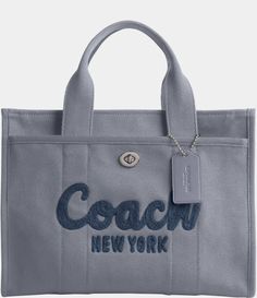 From COACH, the Medium Cargo Tote Bag features:Canvas, grosgrain, and recycled leatherZip-top closureFabric liningOutside turn-lock and snap pocketsFits a 13" laptopHandles with 4.5" dropDetachable strap with 24" drop for shoulder or crossbody wearApprox.: 13.5" L x 10" H x 6.25" WImported. Coach Cargo Tote, Coach Duffle Bag, Coach Tote Bag, Bags Patterns, Tote Bags For School, Shoulder Bags For School, Diy Bags Patterns, Coach Tote Bags, Diy Jewelry Unique