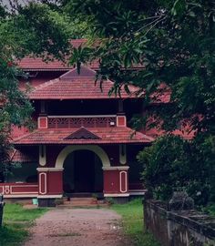 a red and white building surrounded by trees